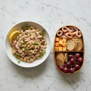 A vibrant spread of no-cook high protein lunches including a tuna bean bowl and a turkey deli bento box.